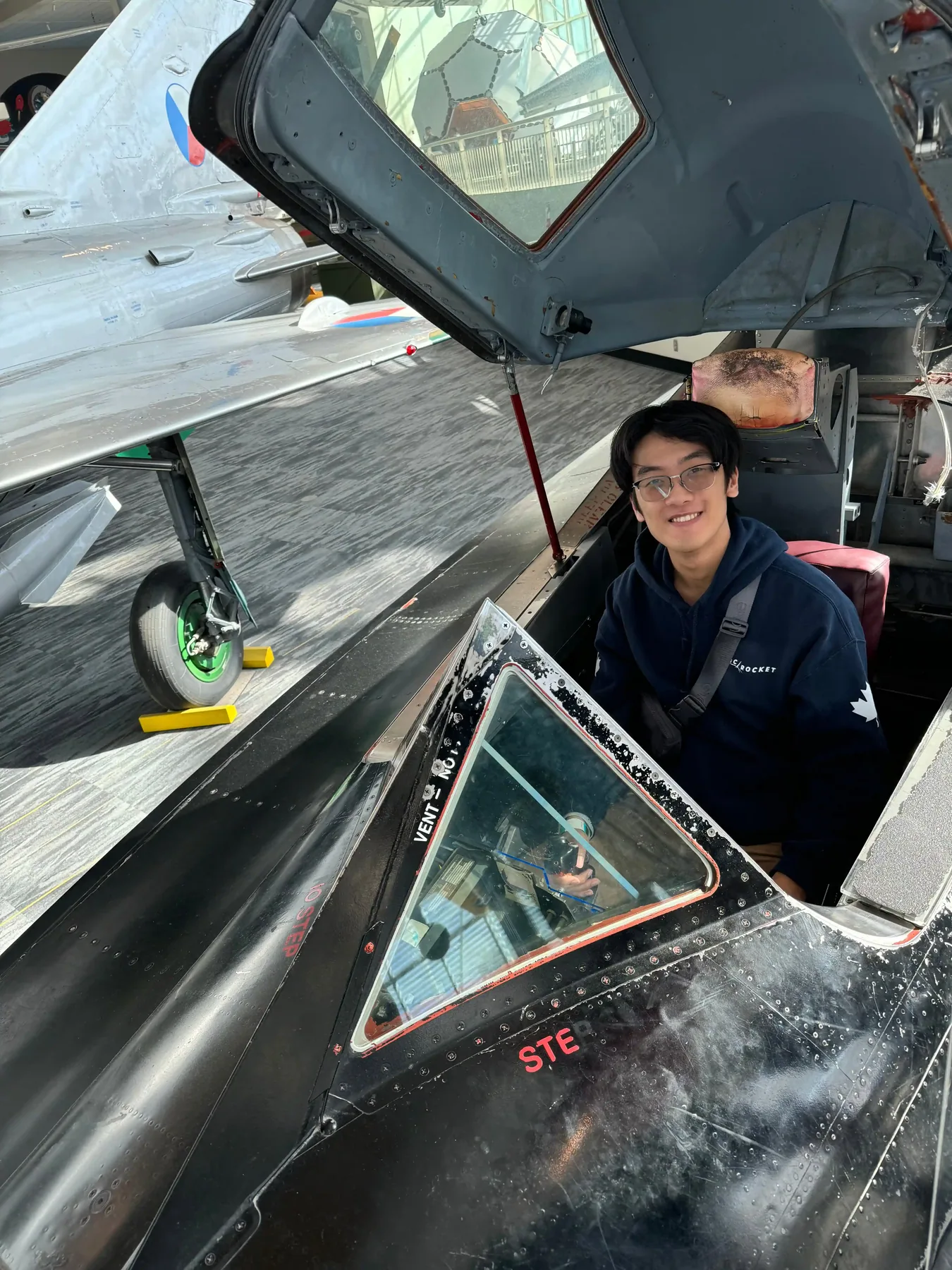 Timothy Cai in the cockpit of a jet aircraft